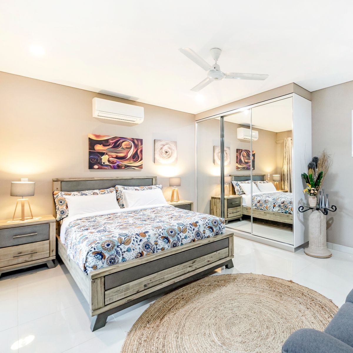 Bedroom With A Large Bed And A Ceiling Fan — Zen Luxury Retreats in Darwin City, NT