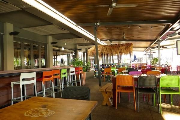 A Fancy Restaurant with Colorful Chairs — Zen Luxury Retreats in Darwin City, NT