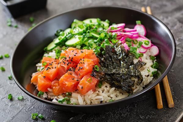 A Black Bowl Filled with Rice , Salmon , Cucumbers , Onions and Seaweed — Zen Luxury Retreats in Darwin City, NT