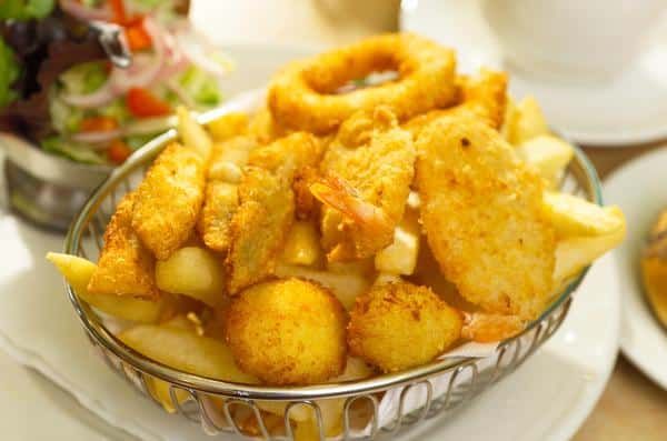 A Basket of Fried Food Is Sitting on A Table — Zen Luxury Retreats in Darwin City, NT