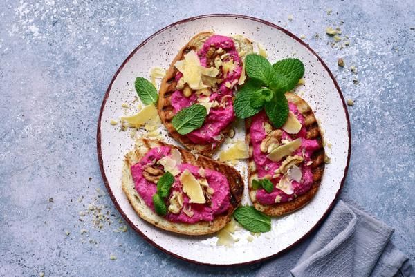 A White Plate Topped with Three Slices of Toast with A Pink Sauce and Mint Leaves — Zen Luxury Retreats in Darwin City, NT