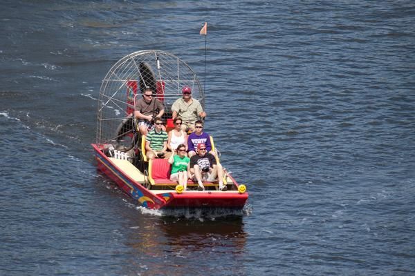 A Group of People Are Riding on A Boat in The Water — Zen Luxury Retreats in Darwin City, NT