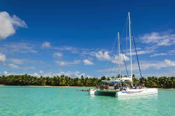 A Catamaran Is Floating on Top of A Turquoise Ocean — Zen Luxury Retreats in Darwin City, NT