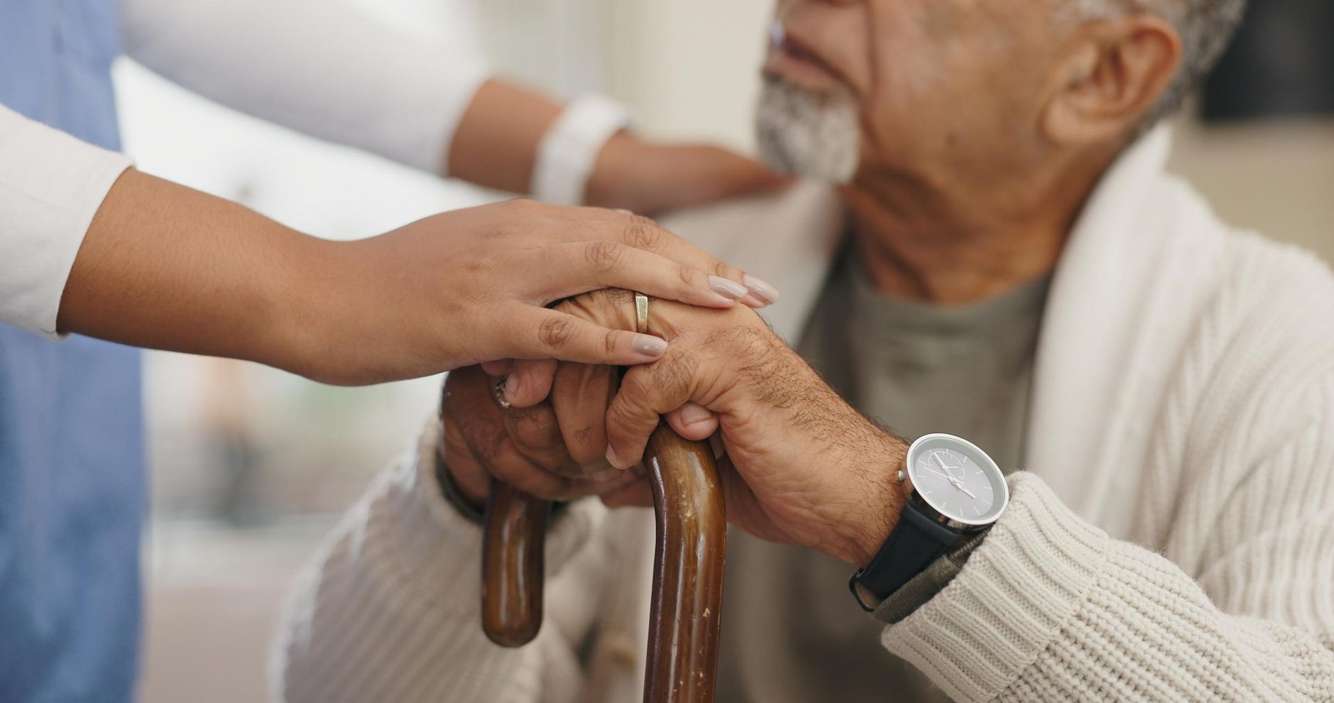 Nurse is Holding the Hand of an Elderly Man With a Cane — Serenity Strides in Logan, QLD