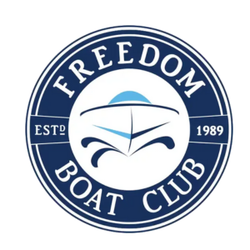 The logo for the freedom boat club has a boat in the center.