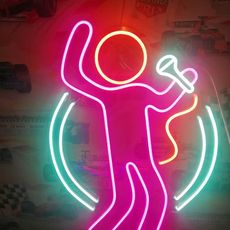 A neon sign of a person holding a microphone.