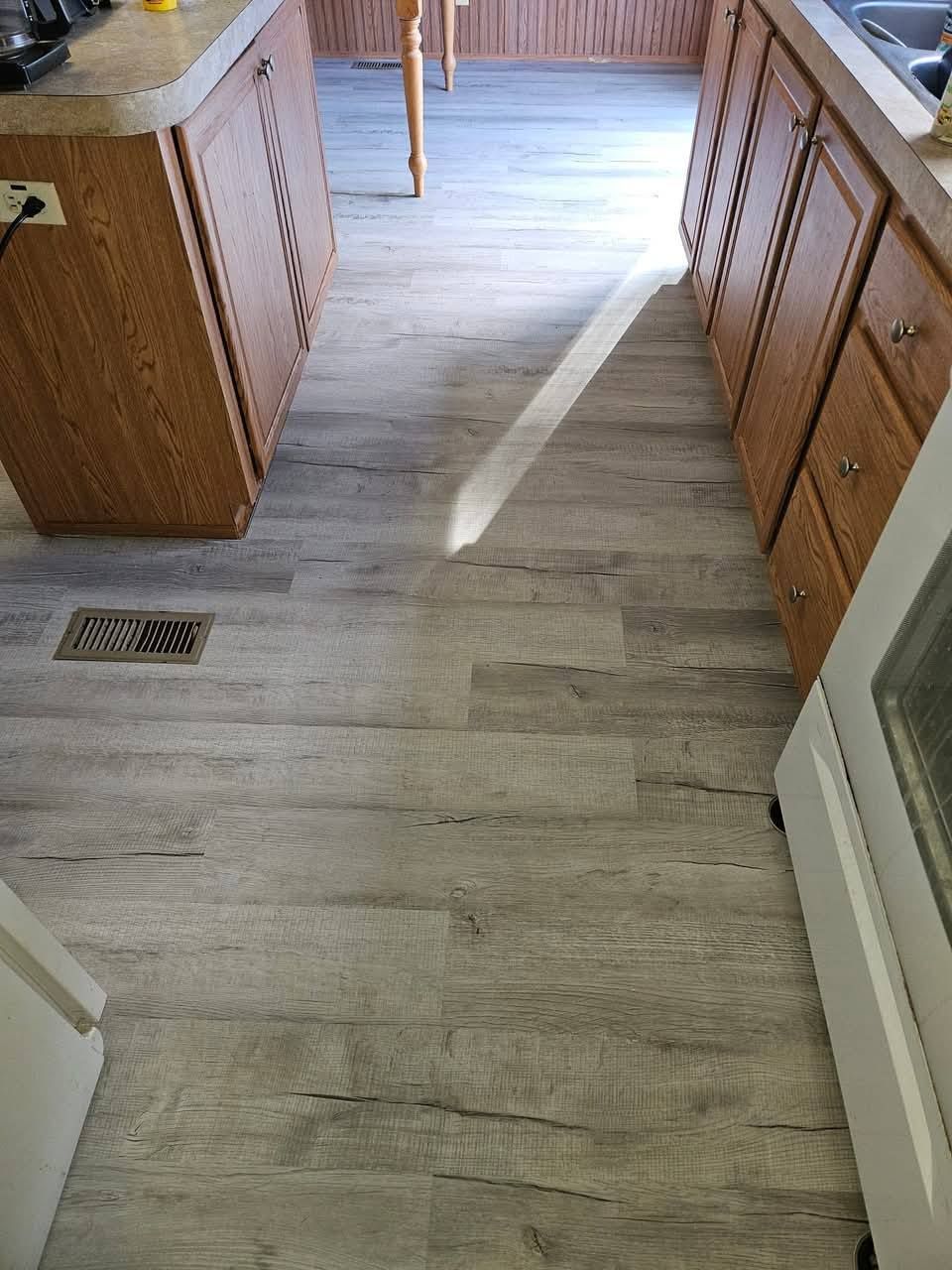 A kitchen with wooden cabinets and a white stove.