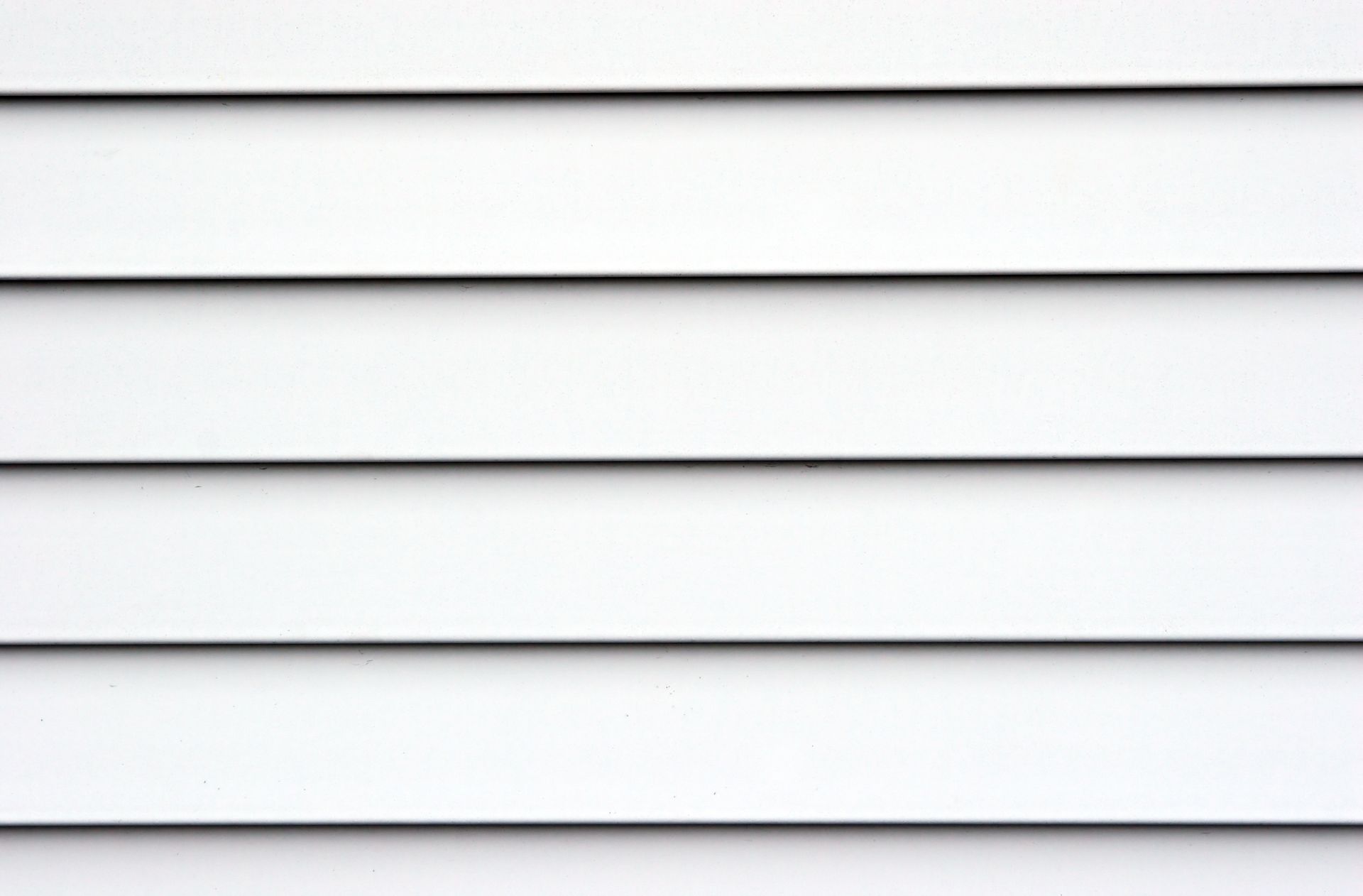White horizontal siding with black lines.