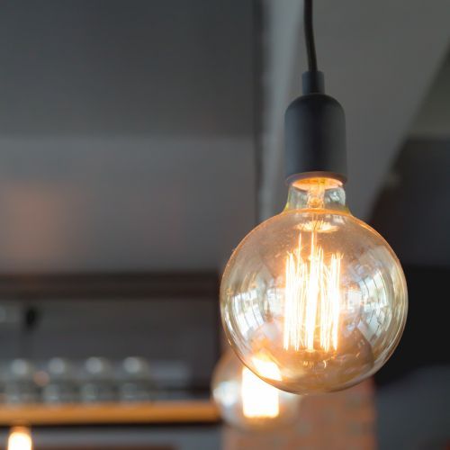 A close up of a light bulb hanging from the ceiling