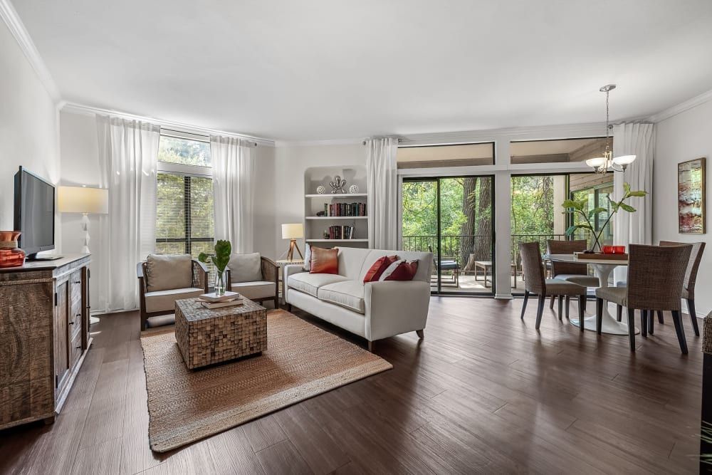 a living room with a couch, chairs, a table, and a television at Marquis at Caprock Canyon in Austin, TX.