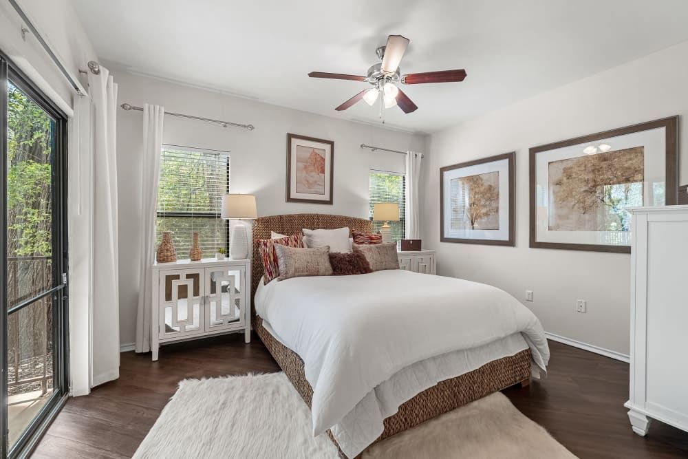 a bedroom with a large bed and a ceiling fan at Marquis at Caprock Canyon in Austin, TX.