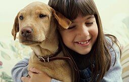 Young Girl Hugging Her Dog — Veterinary Hospital in chesterfield, MI