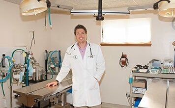 Doctor Standing in Front of Medical Equipments — Veterinary Hospital in chesterfield, MI