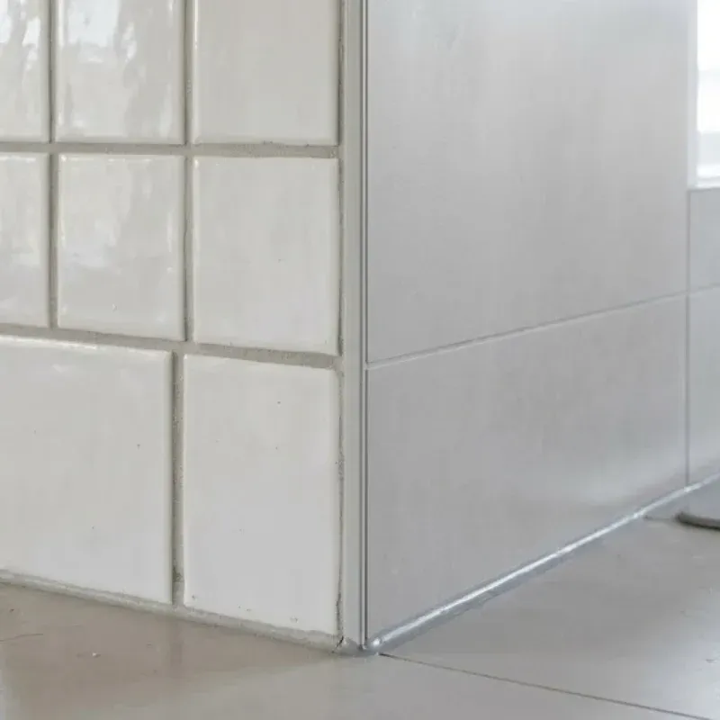 Tile flooring with grout lines in a Lafayette kitchen showing proper seam placement near sink and dishwasher for moisture protection
