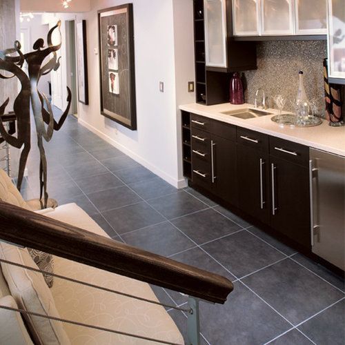 A kitchen with black cabinets and stainless steel appliances