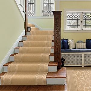 A staircase with a carpet on the steps in a living room.