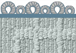 A close up of a gray carpet with a blue border.