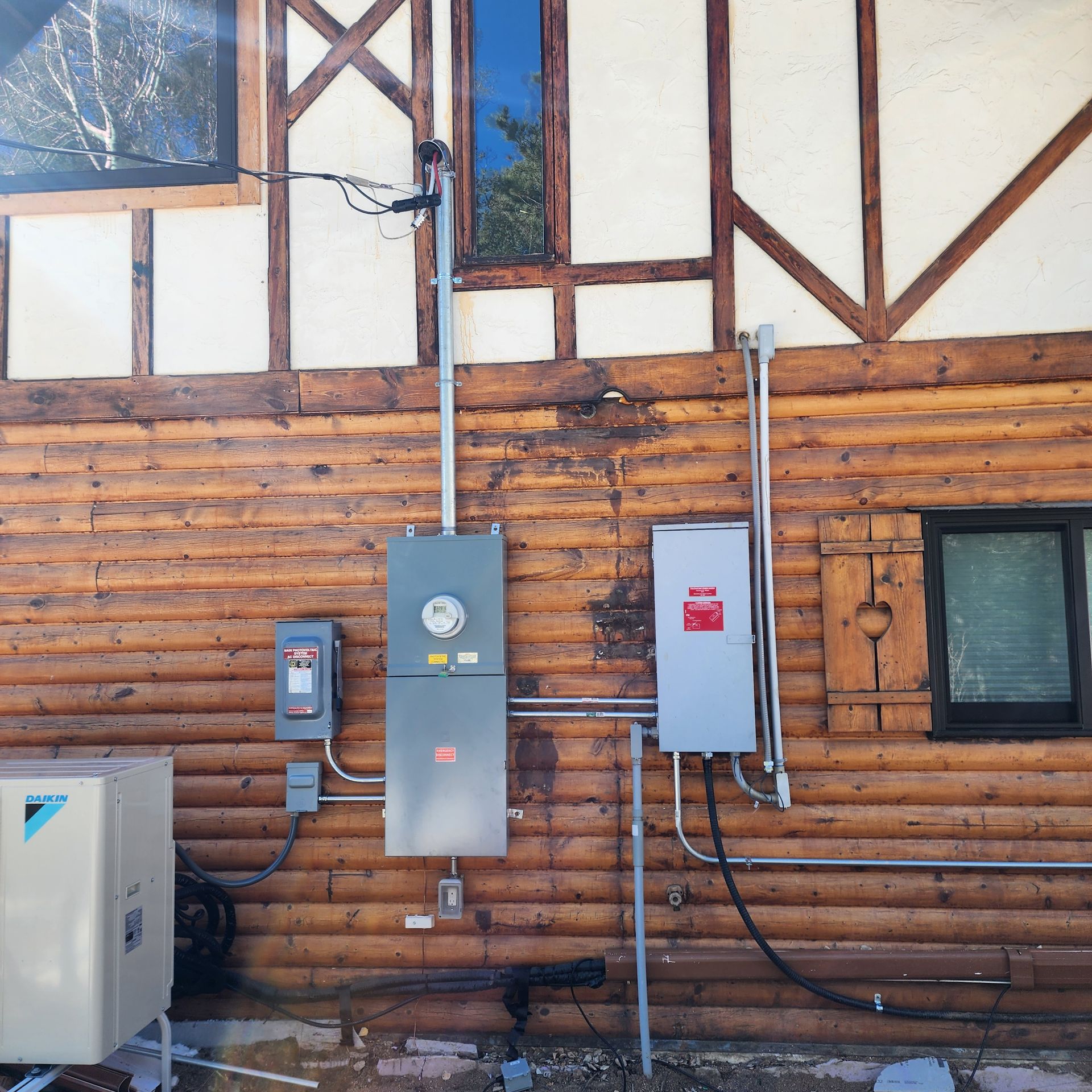 A wooden wall with electrical boxes on it