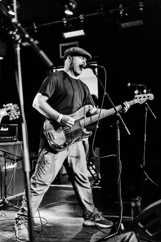 A man is playing a zildjian drum set