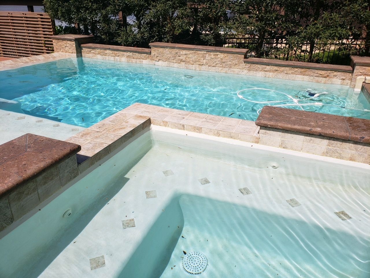A large swimming pool with stairs leading to it