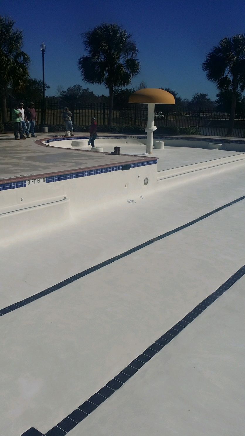 A swimming pool with a yellow umbrella on top of it