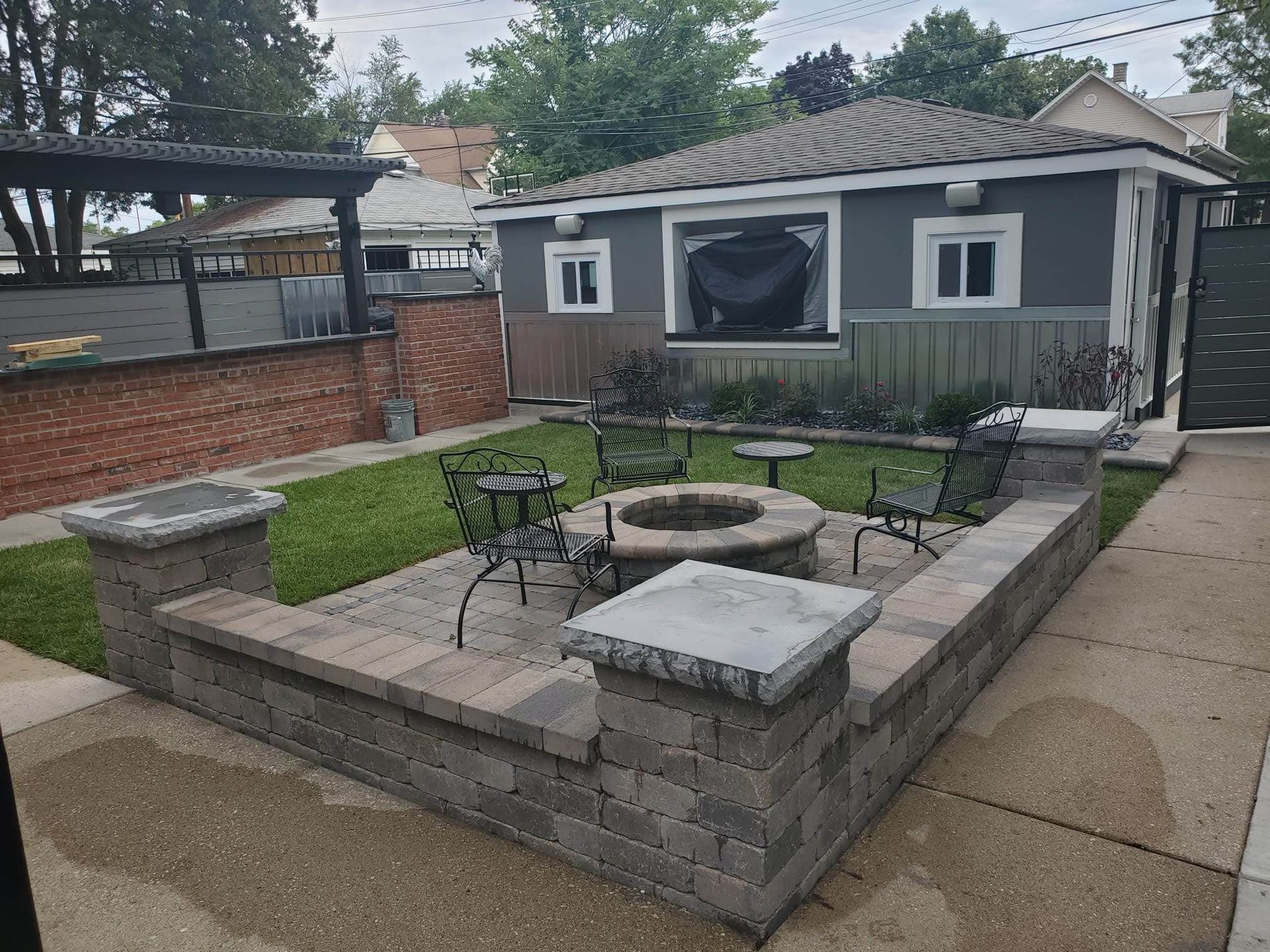 A brick walkway is being built in a garden.