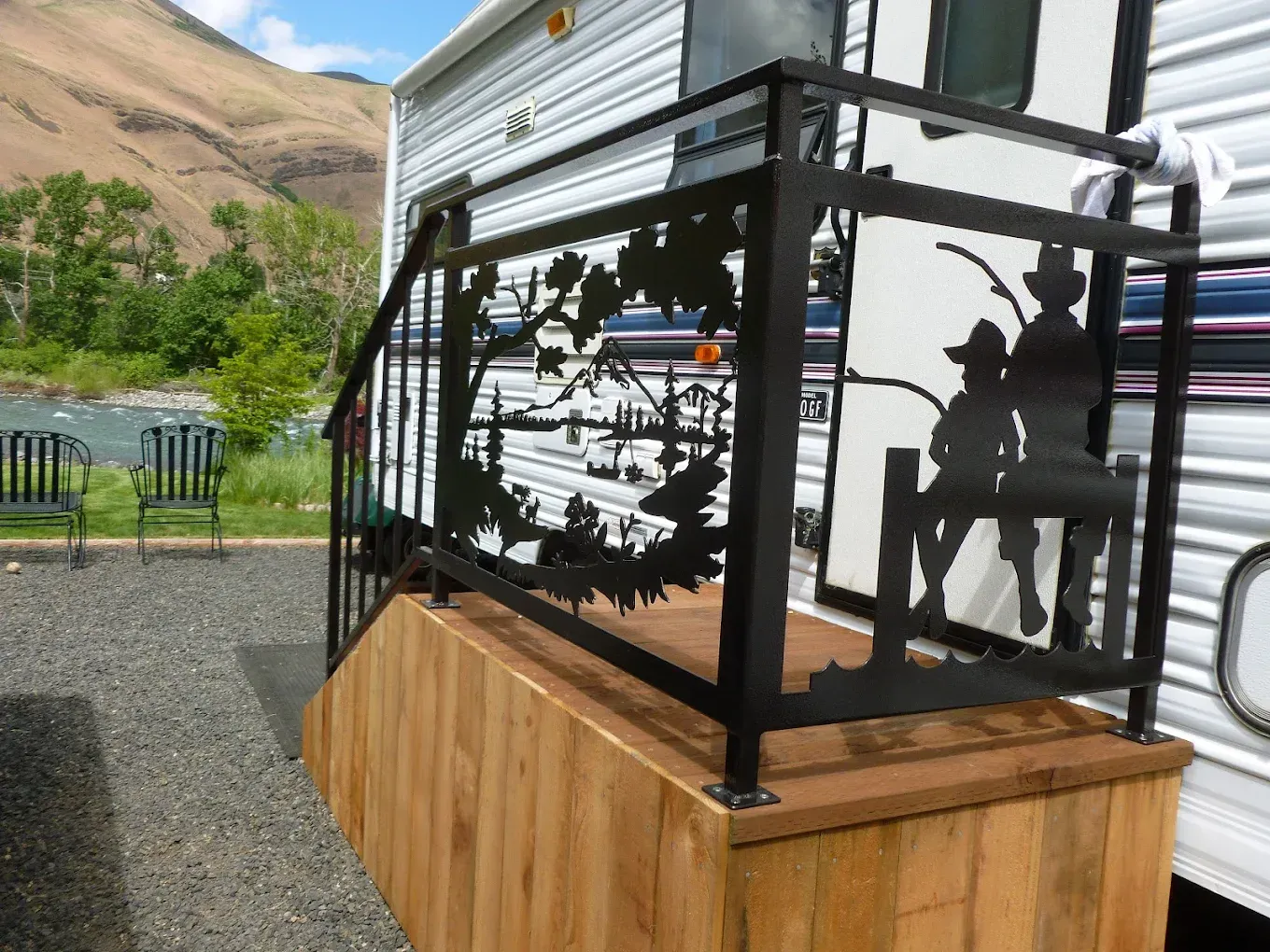 Custom welded steel railing with decorative cut-out metal panel design