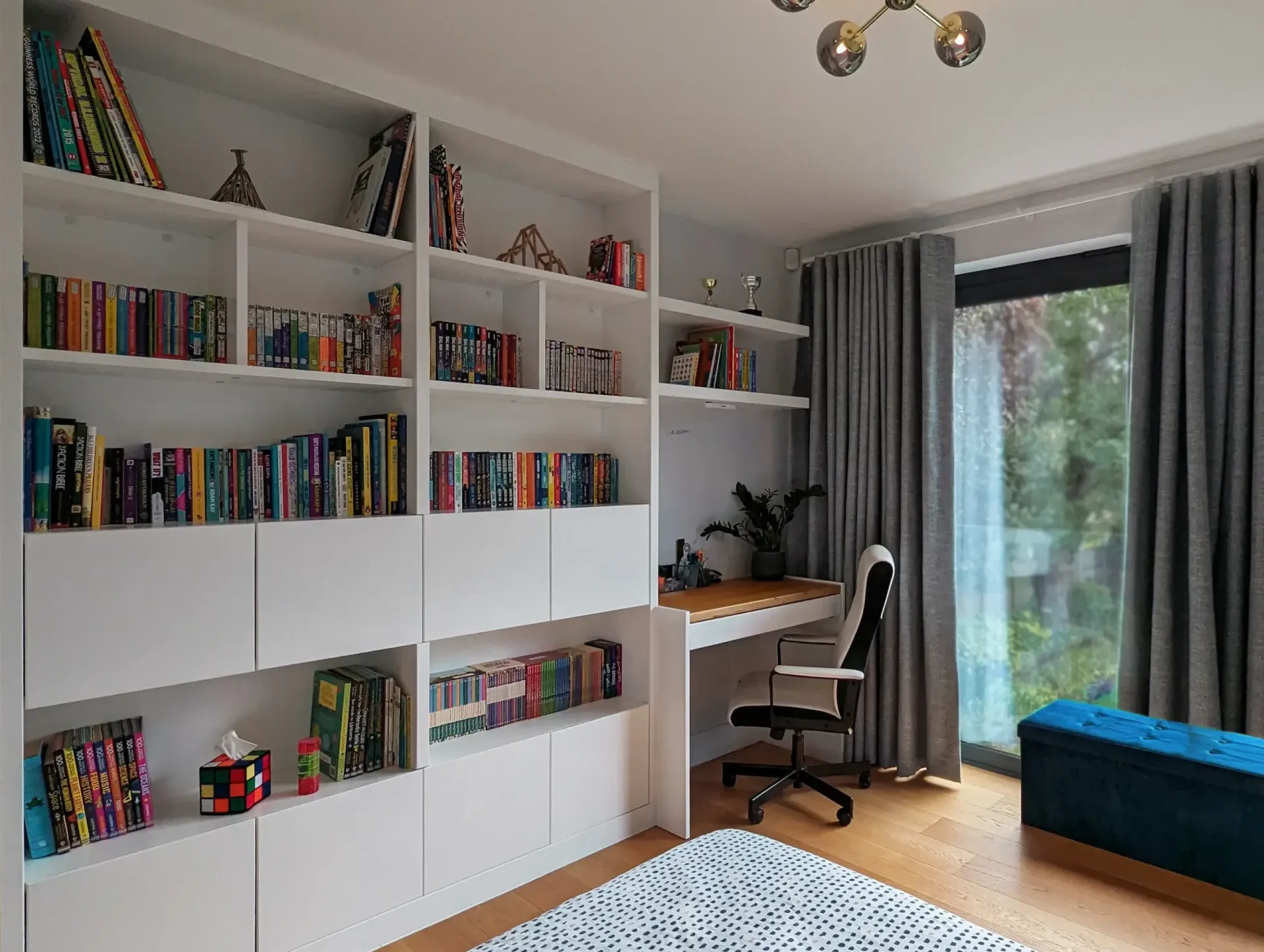 An empty attic with hardwood floors and a skylight.