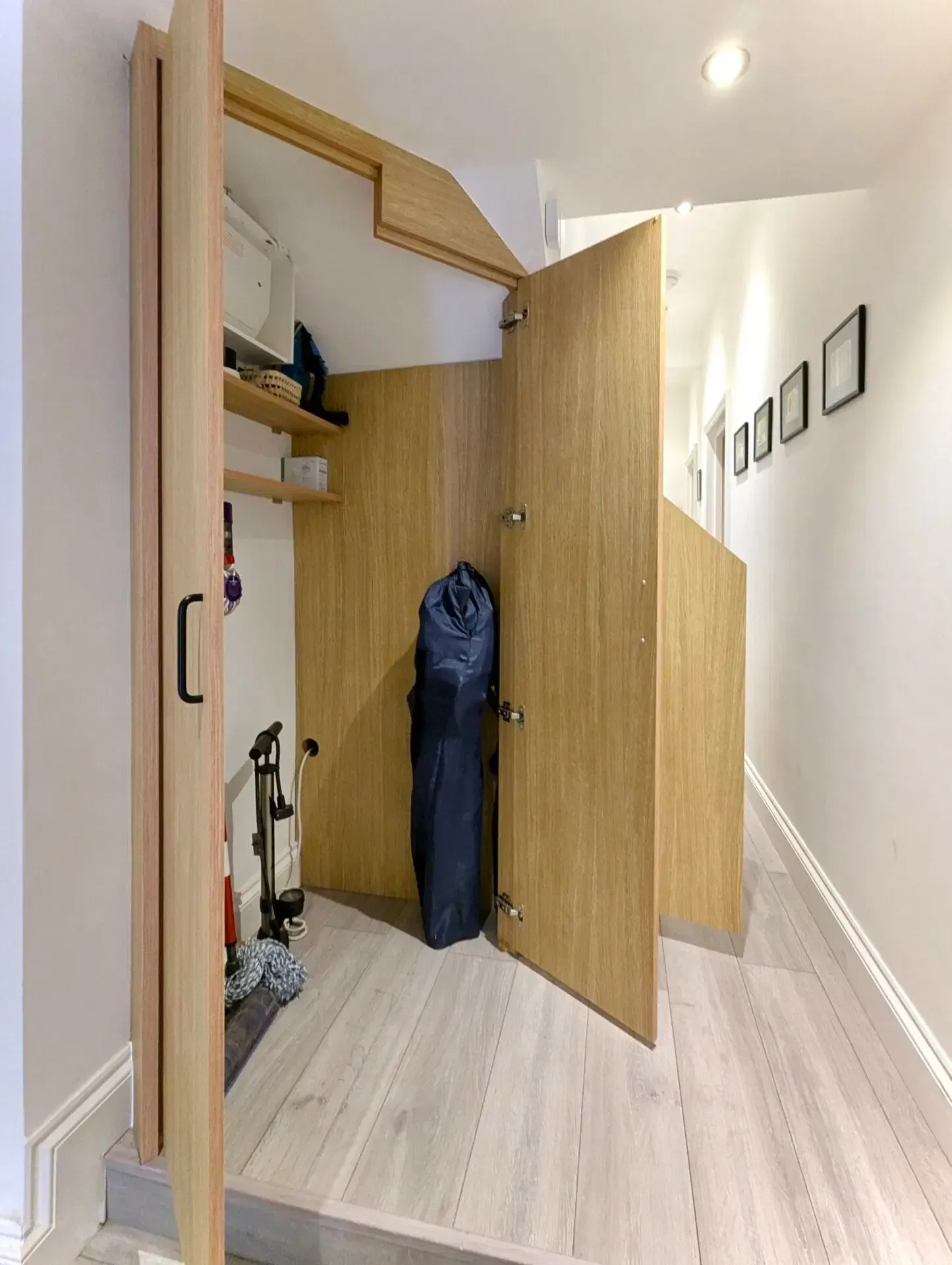 An empty attic with hardwood floors and a skylight.