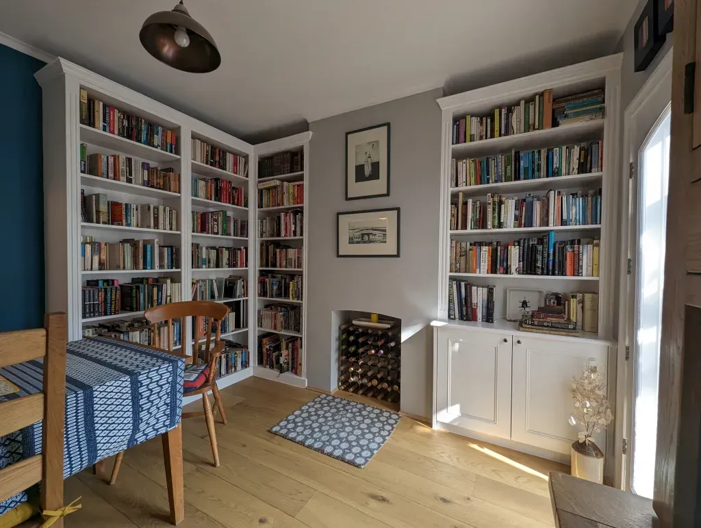 An empty attic with hardwood floors and a skylight.