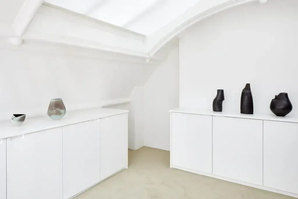 An empty attic with hardwood floors and a skylight.