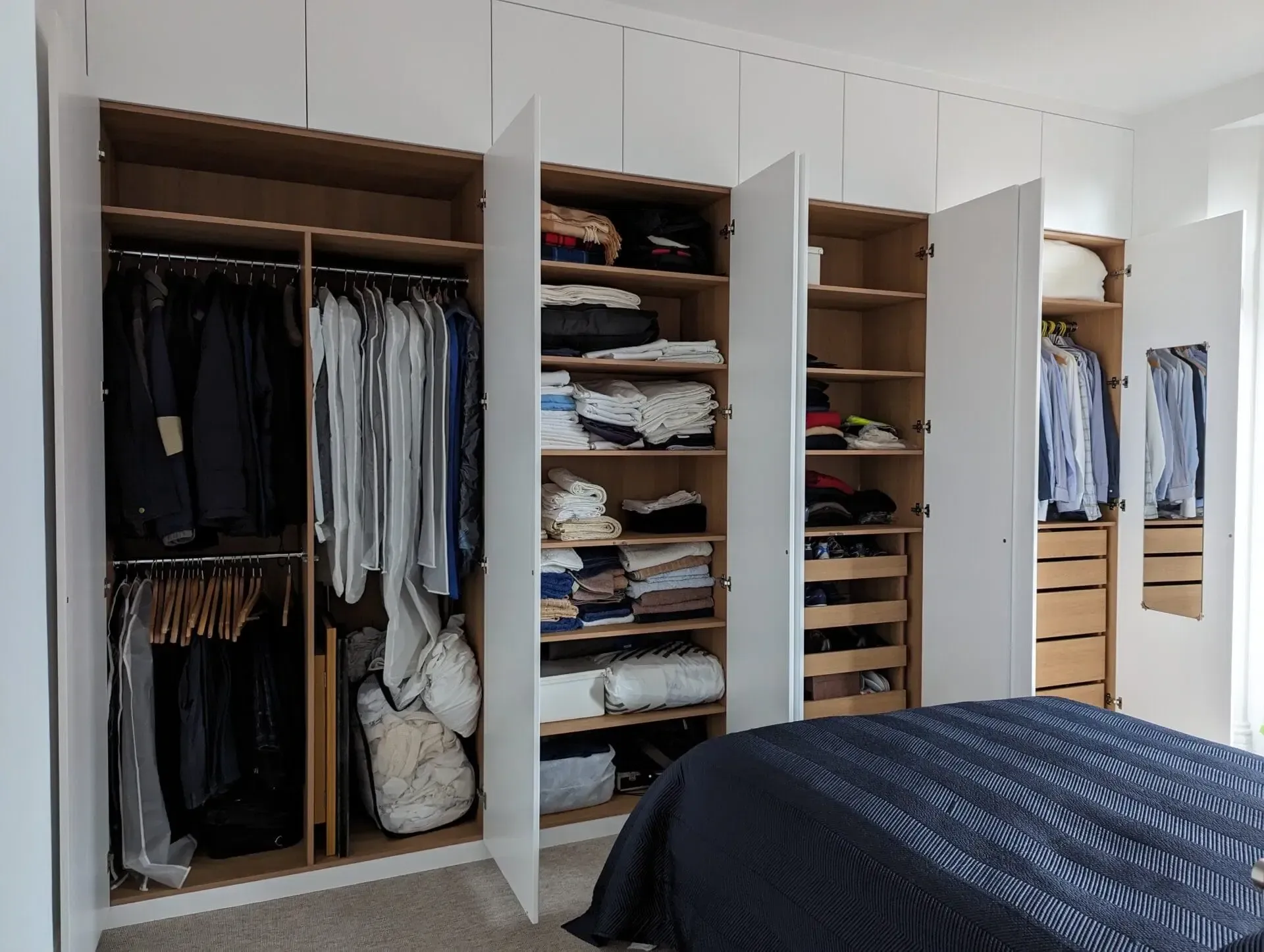 An empty attic with hardwood floors and a skylight.