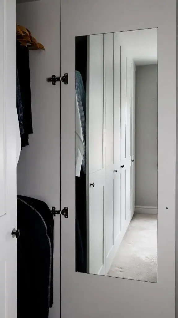 An empty attic with hardwood floors and a skylight.