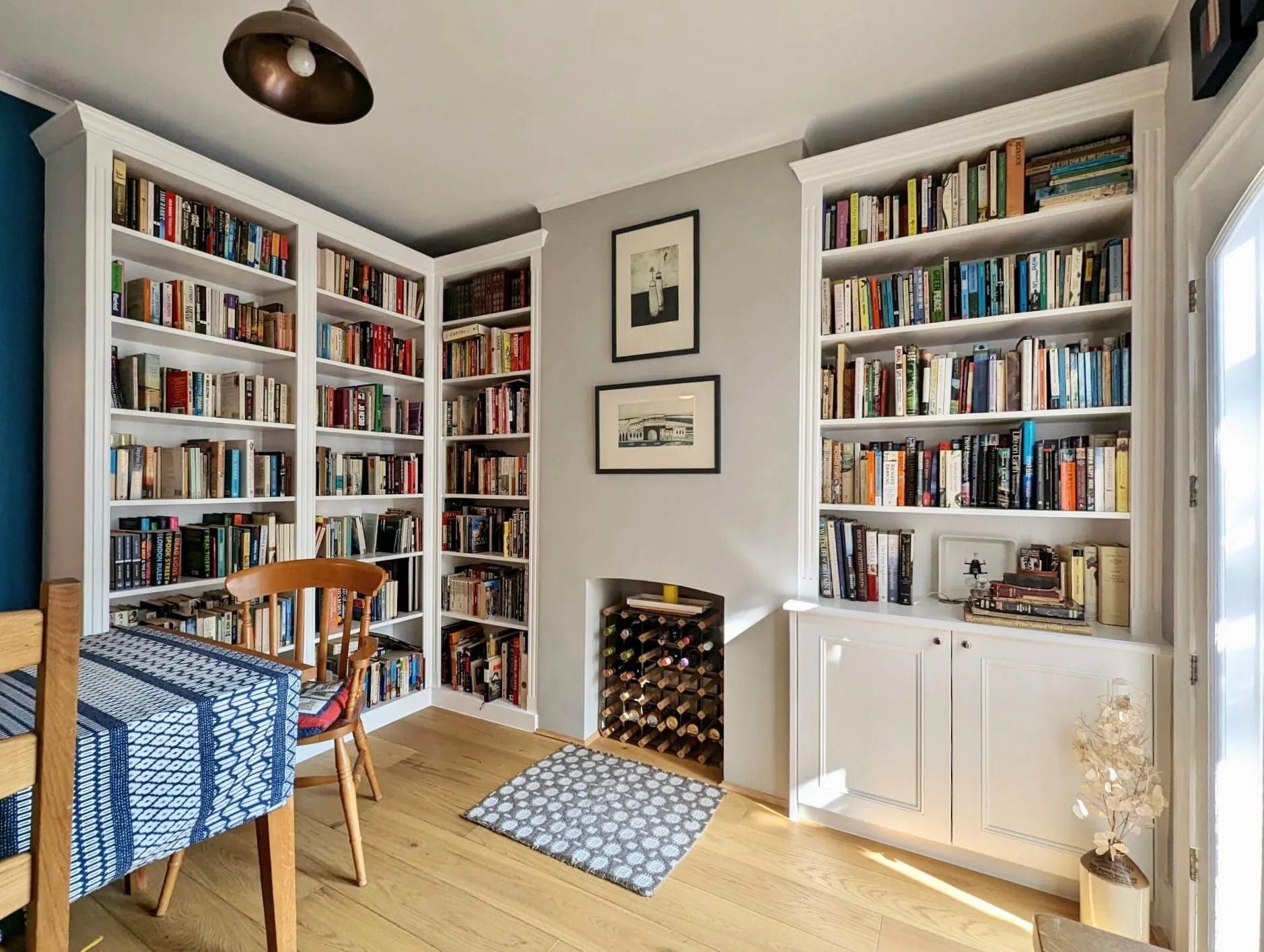 An empty attic with hardwood floors and a skylight.