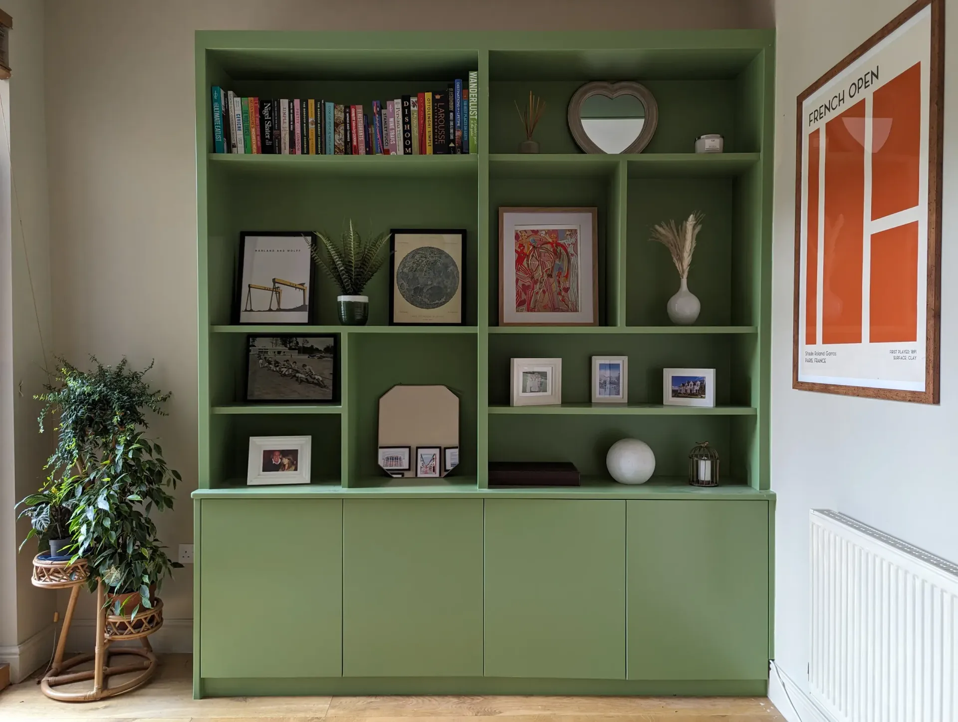 An empty attic with hardwood floors and a skylight.