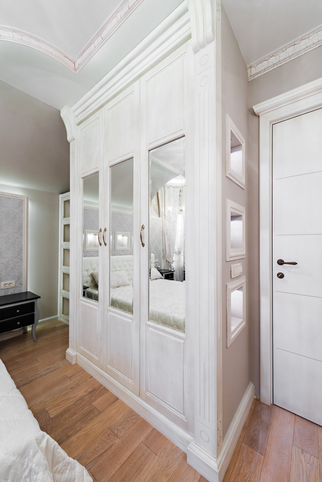 An empty attic with hardwood floors and a skylight.