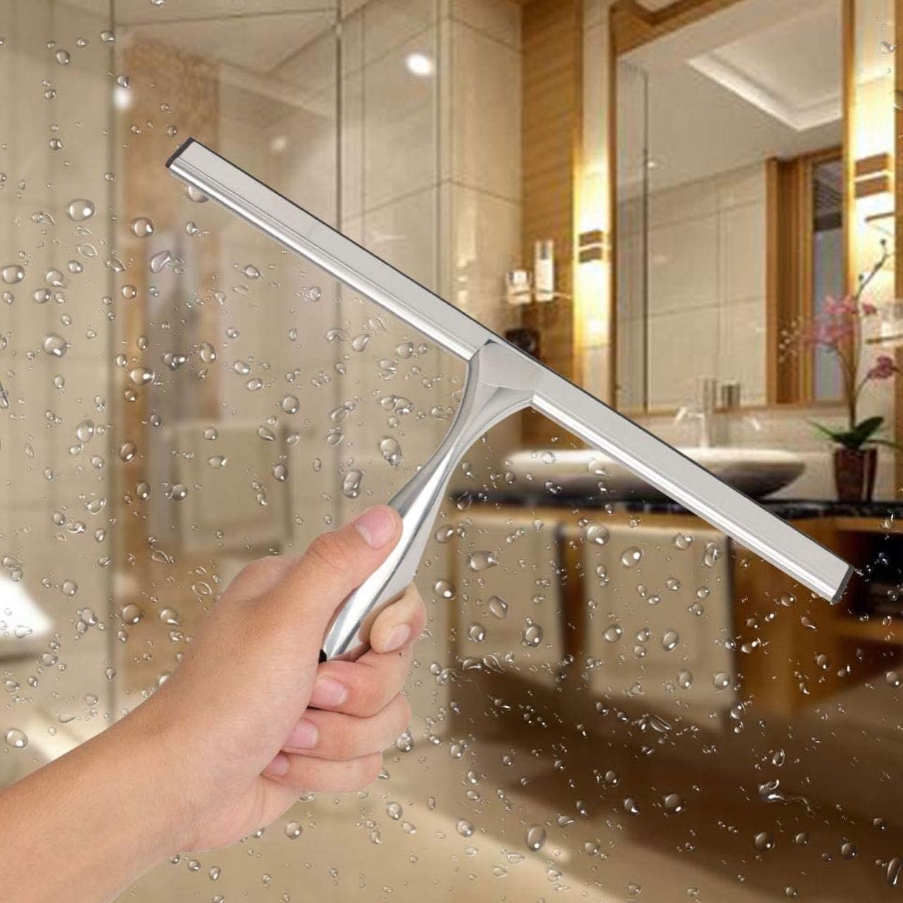 A person is holding a squeegee in front of a bathroom window