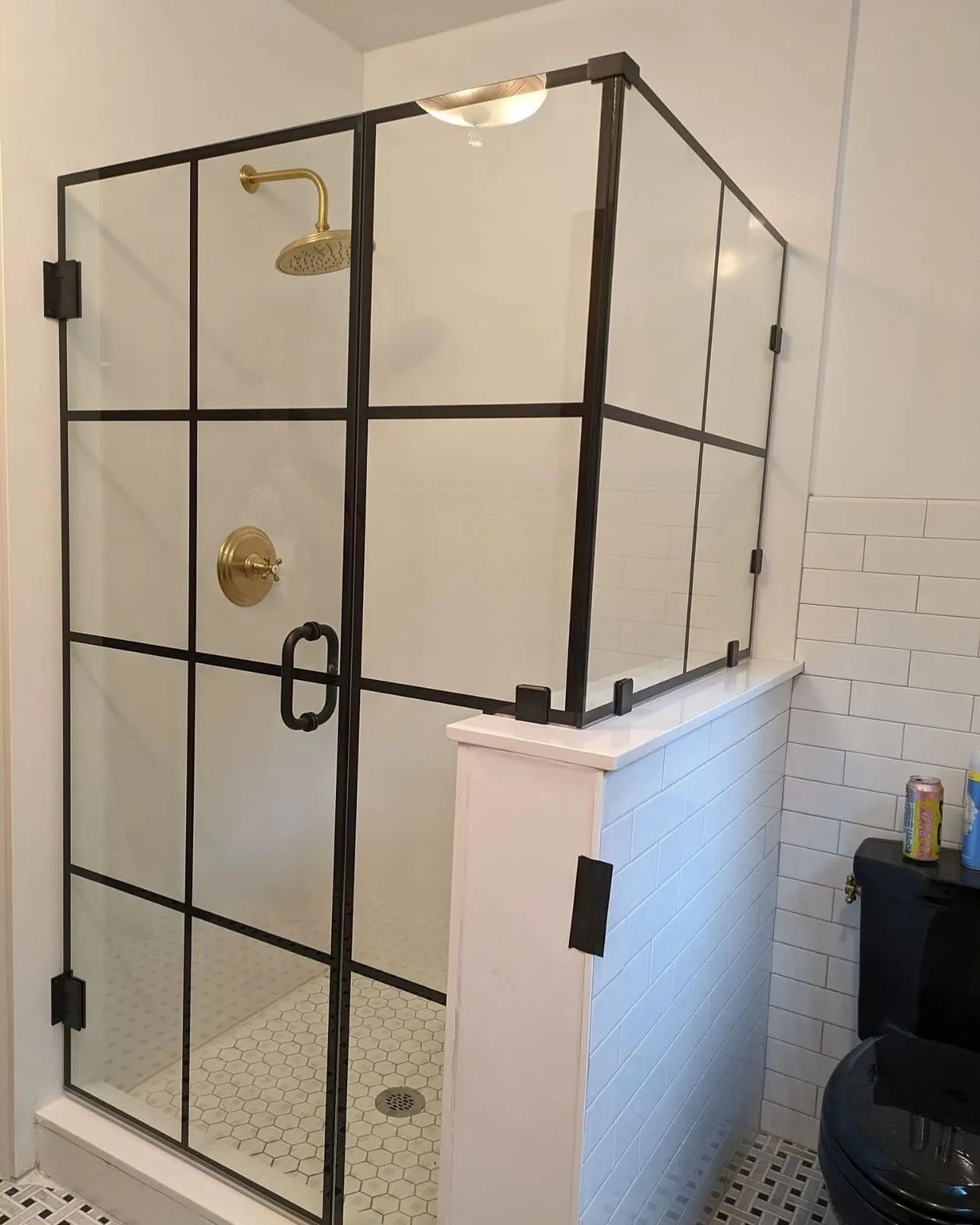 Black framed glass shower enclosure with brass gold fixtures - Ocean Glass