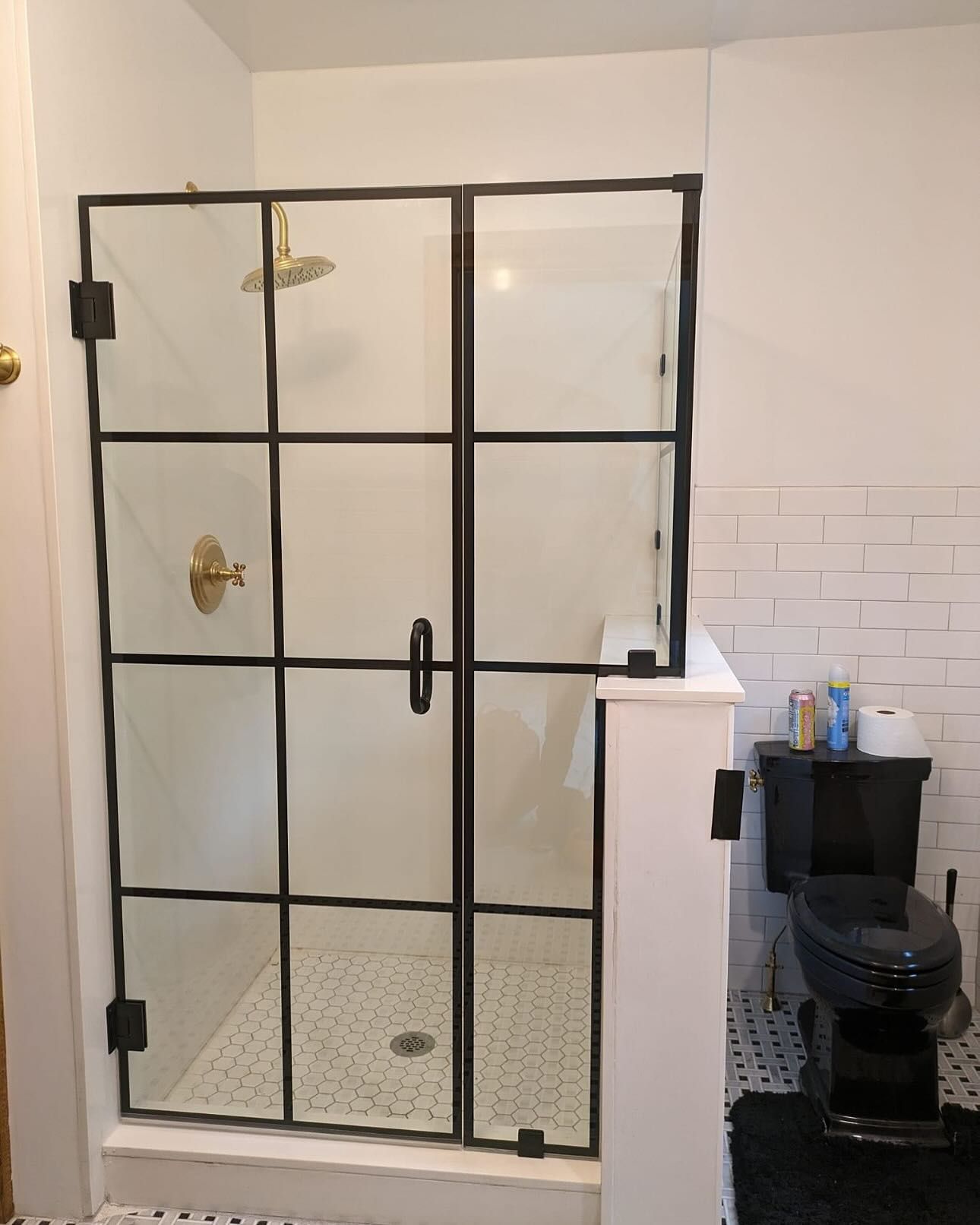 A bathroom with a walk in shower and a toilet