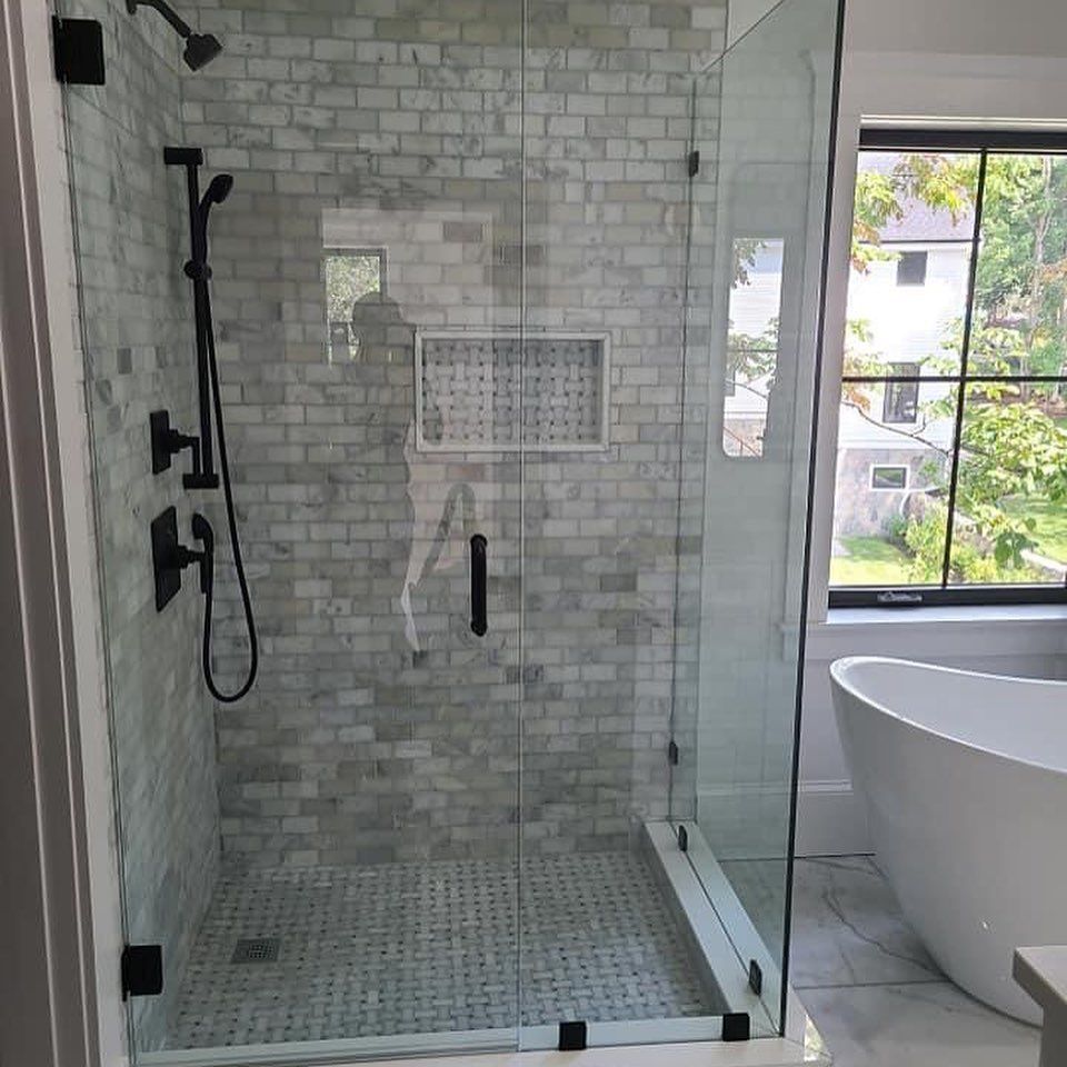 A bathroom with a walk in shower and a bathtub.