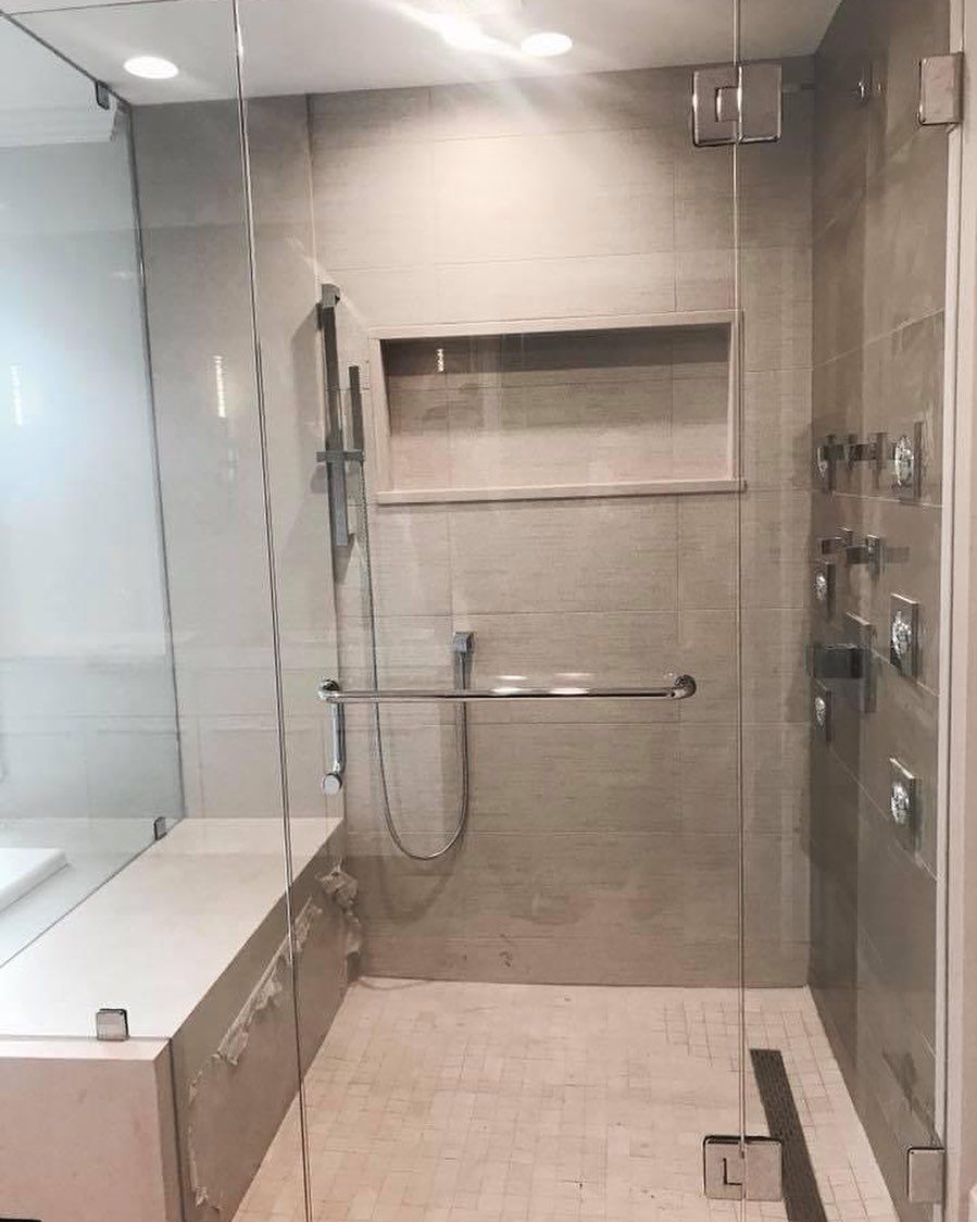 A bathroom with a walk in shower and a toilet.