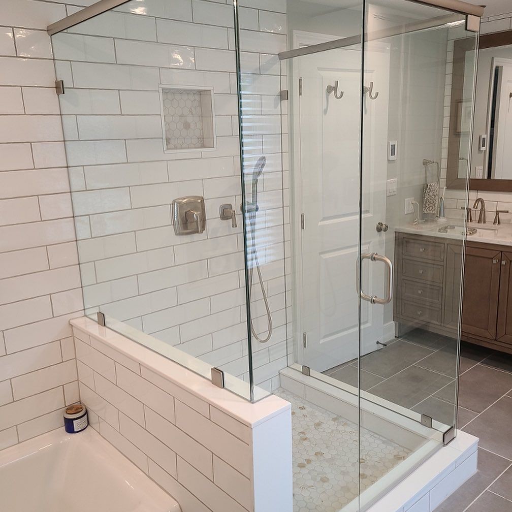 A bathroom with a walk in shower and a bathtub
