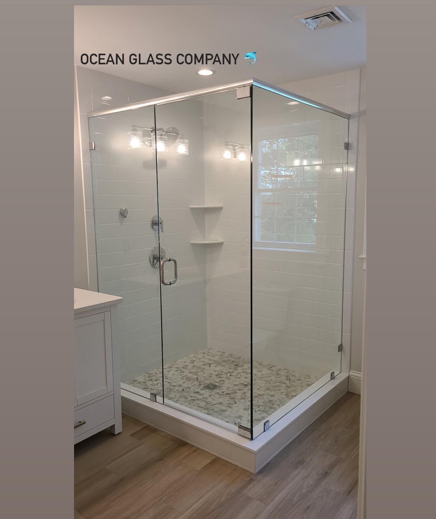 A bathroom with a shower stall and a sink.