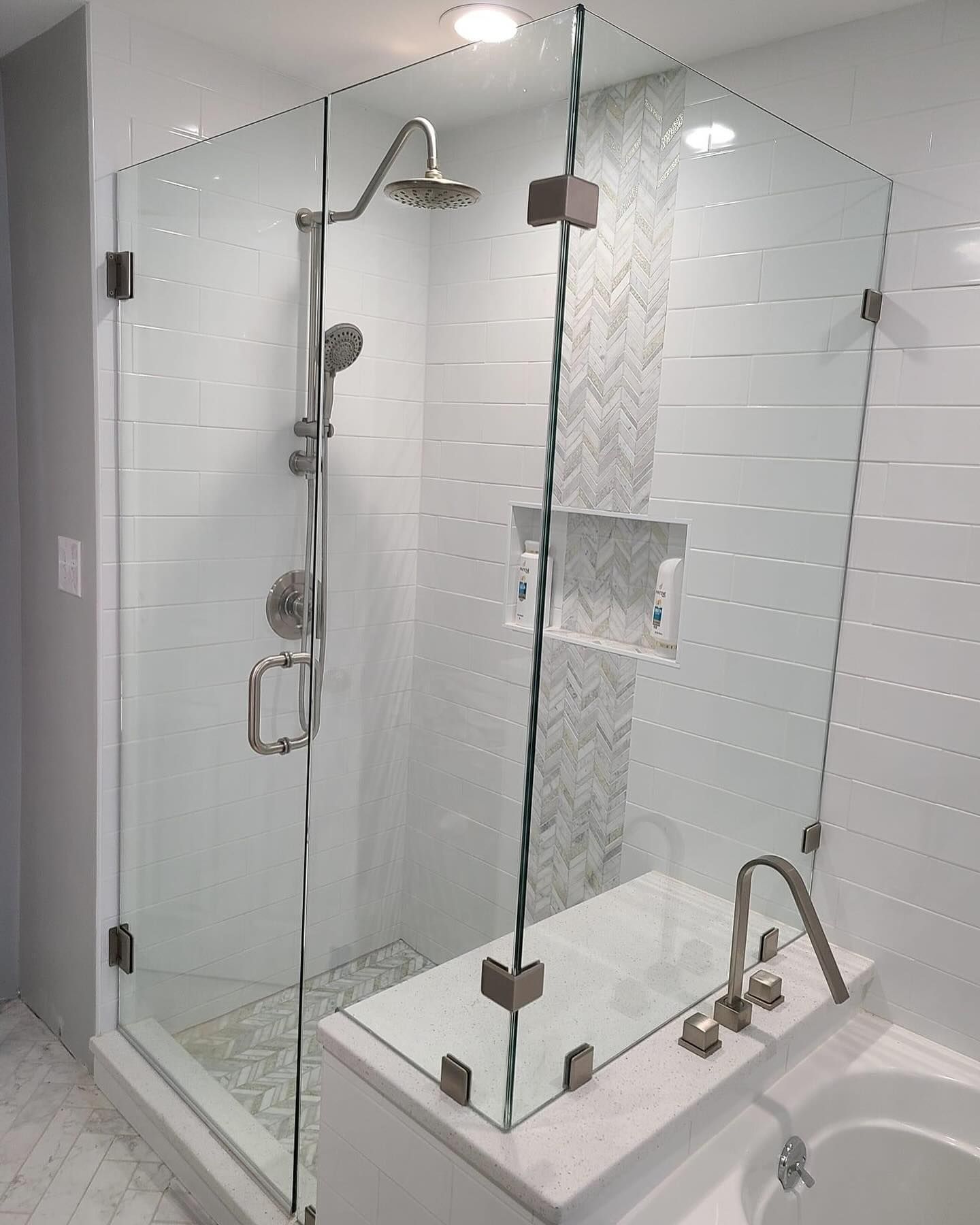 A bathroom with a walk in shower and a bathtub.