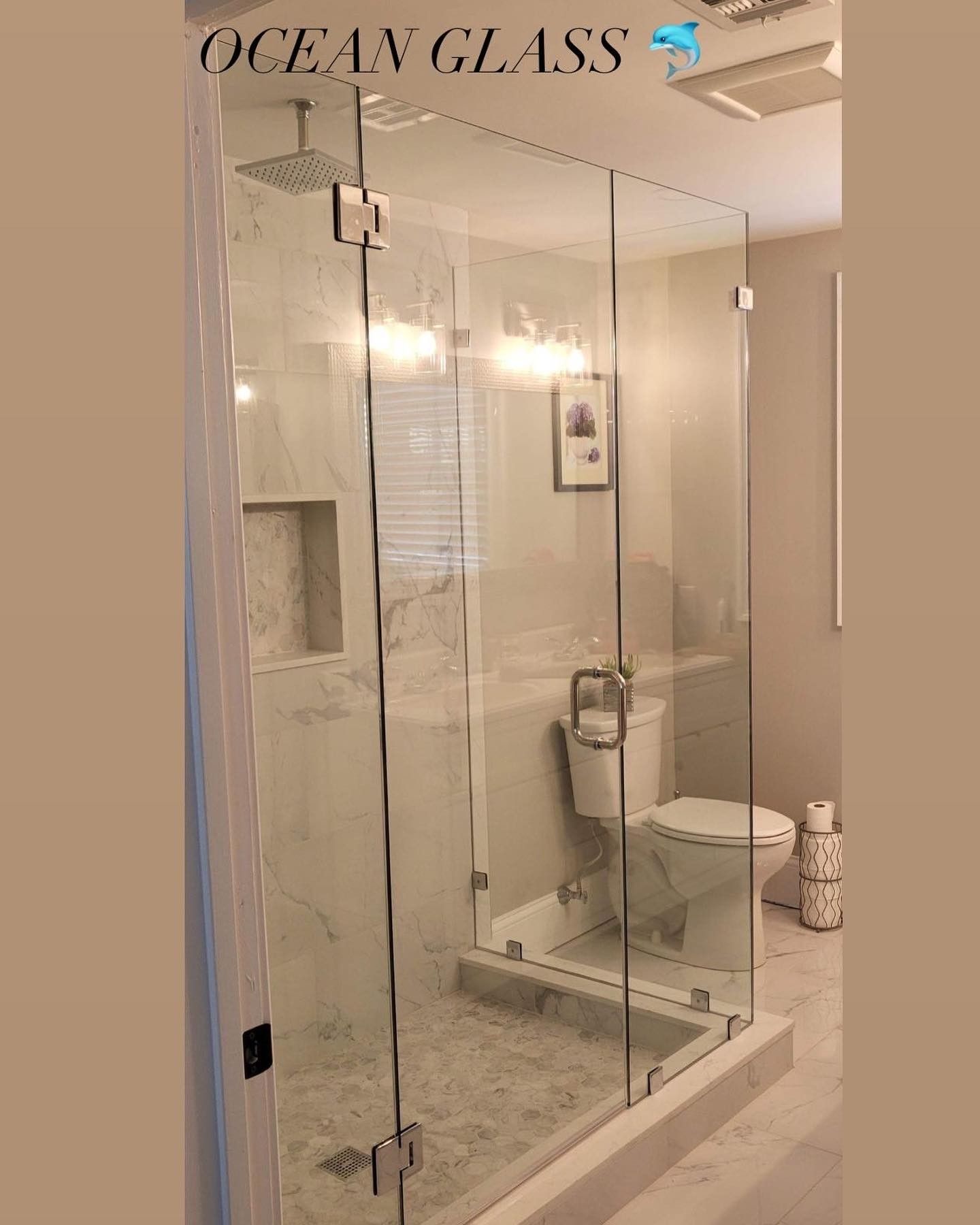 A bathroom with a toilet and a shower stall with a glass door.
