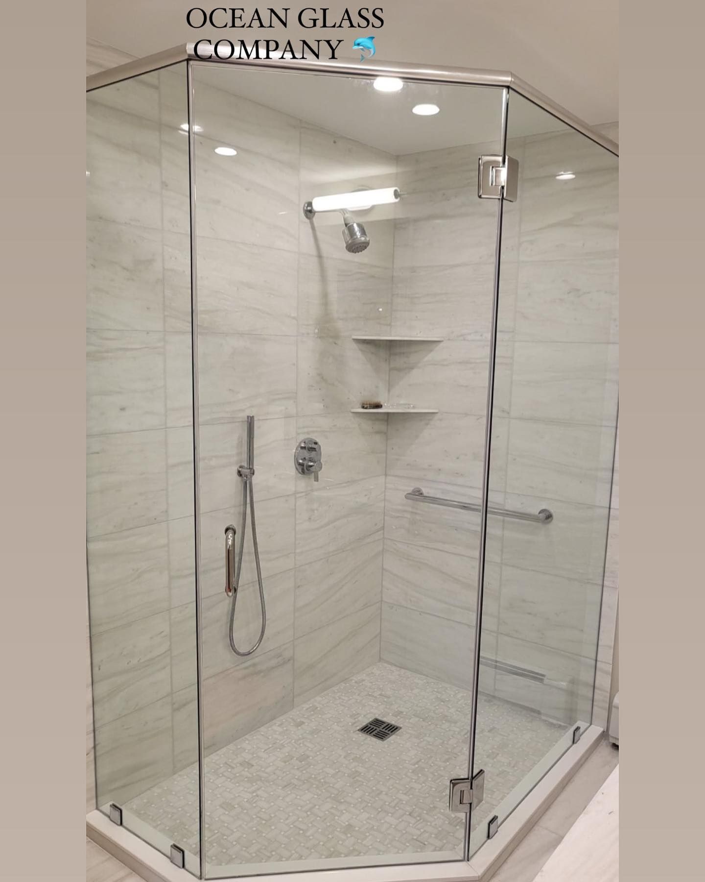 A shower stall with a glass door and a shower head.