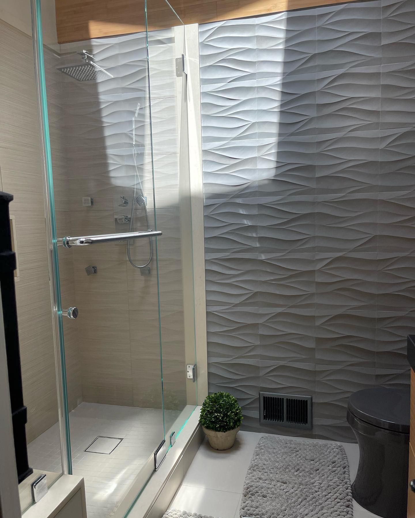 A bathroom with a walk in shower and a toilet.