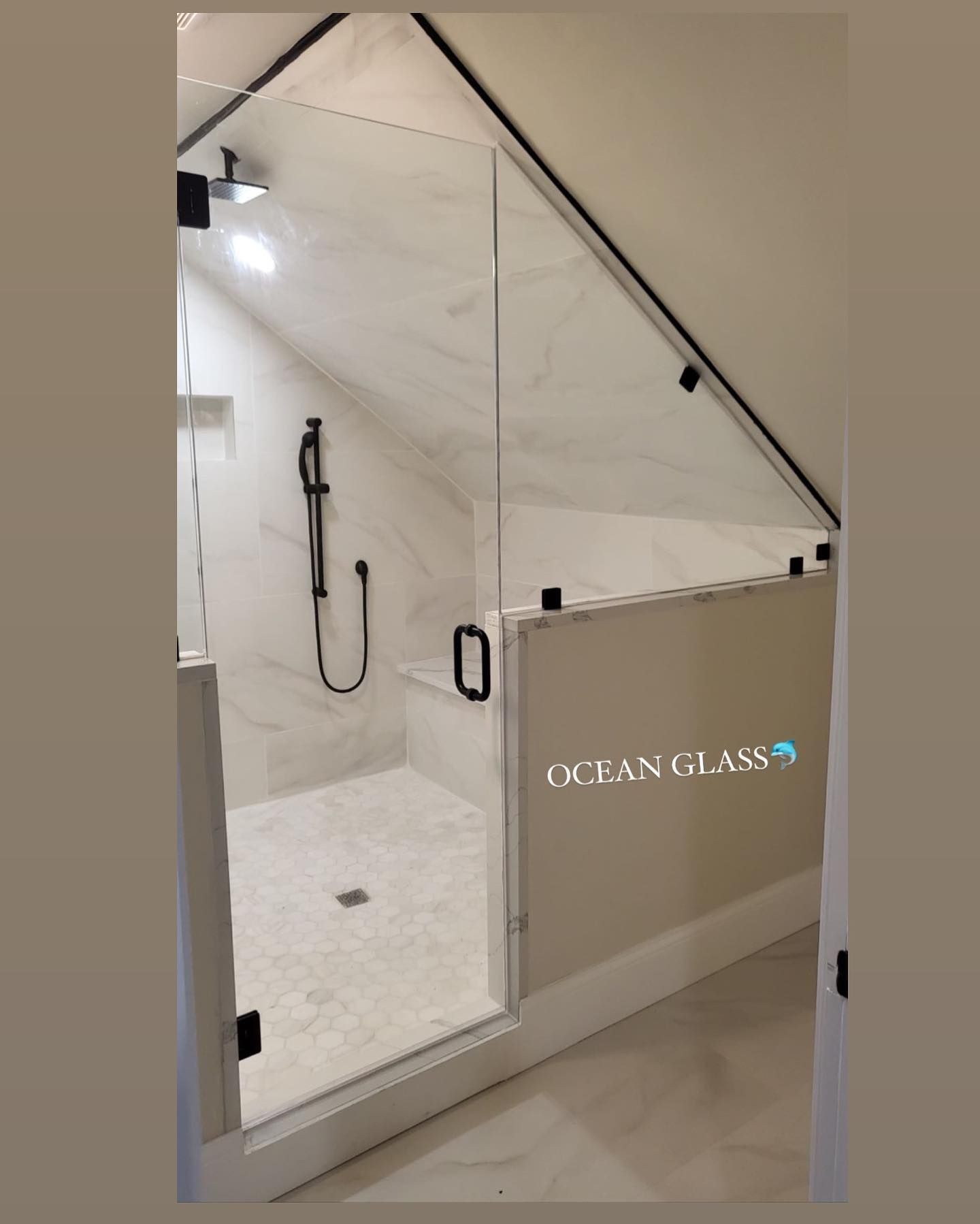 A bathroom with a shower and a sign that says ocean glass