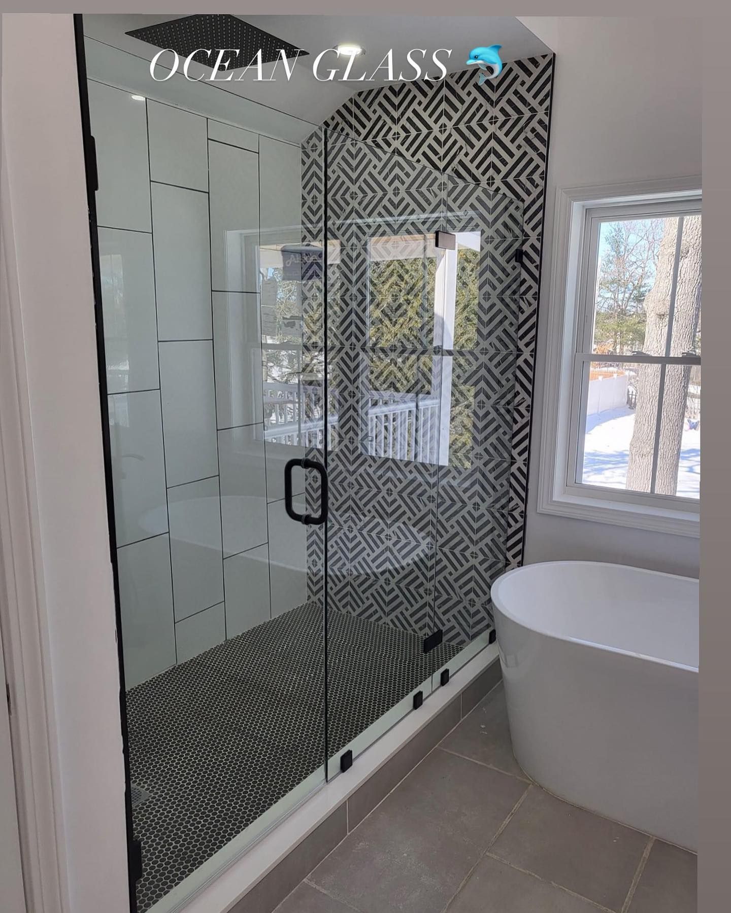 A bathroom with a walk in shower and a bathtub.