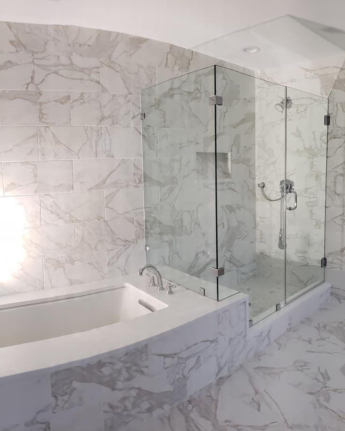 A bathroom with a bathtub and a shower stall